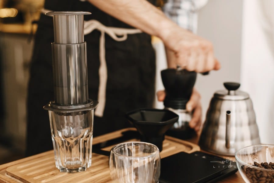 Professional Barista Preparing Coffee by Aeropress Alternative Method, Brewing Process. Hands on Aeropress and Glass Cup, Sca