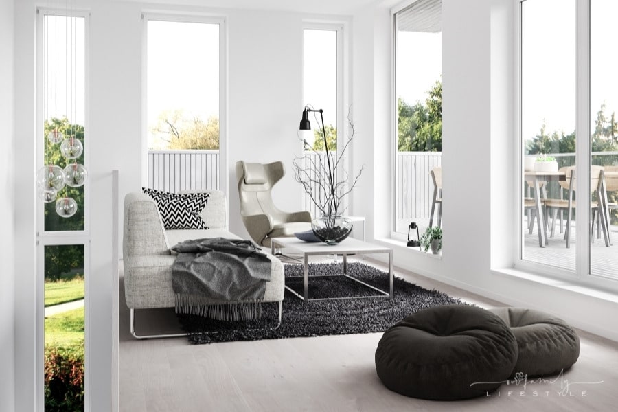 modern living space with black rug and grey furniture