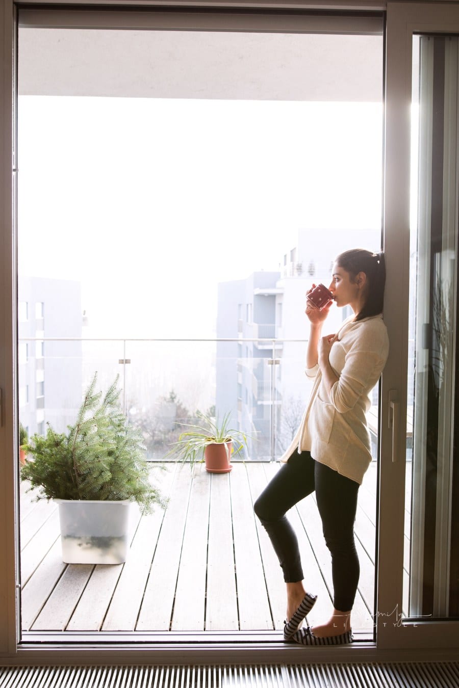 Woman Relaxing on Balcony
