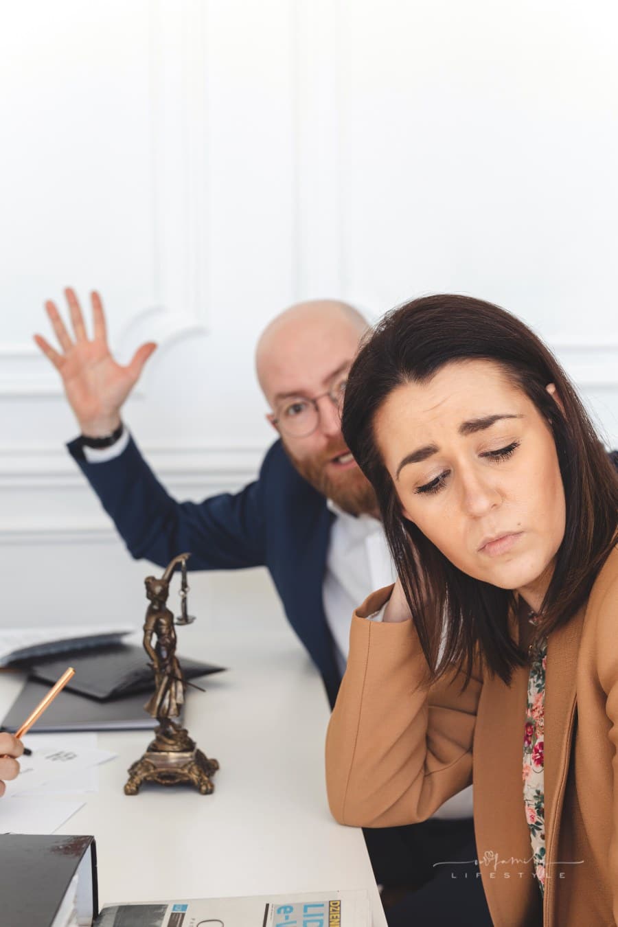 couple arguing in divorce lawyers office