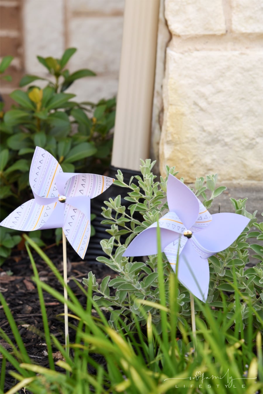 DIY Cricut paper pinwheels in flower bed