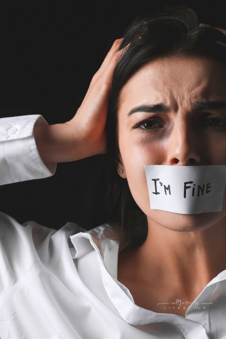 scared female victim with mouth taped over with words, "I'm fine."