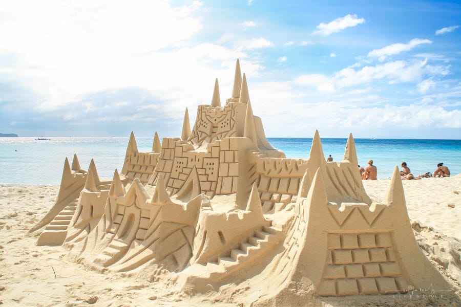 large sand castle on sunny beach