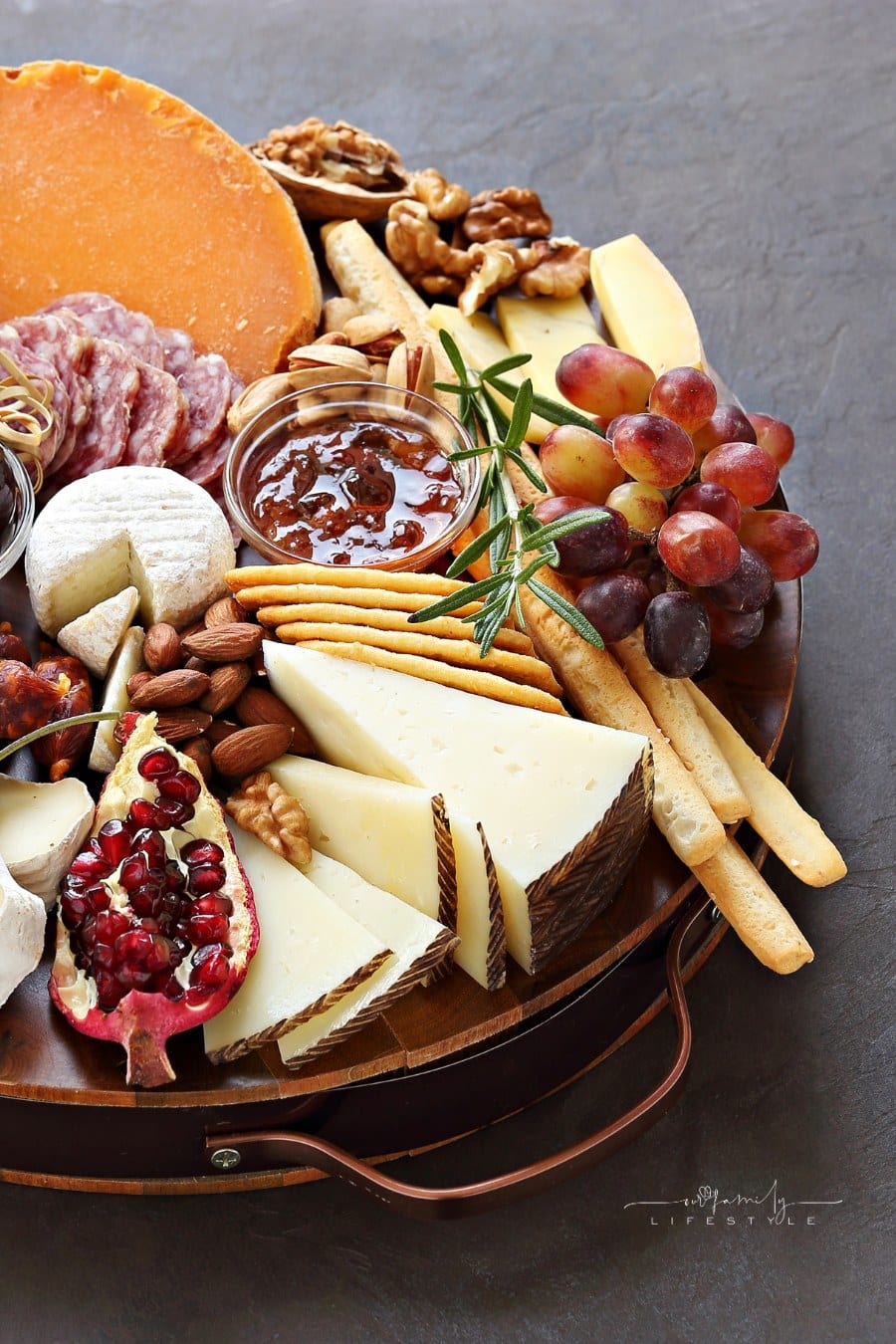 Appetizers platter with various of cheese, sausage, fruits and nuts. Cheese board.