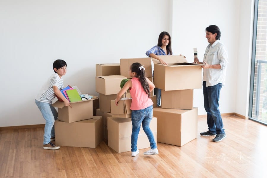 family packing moving boxes