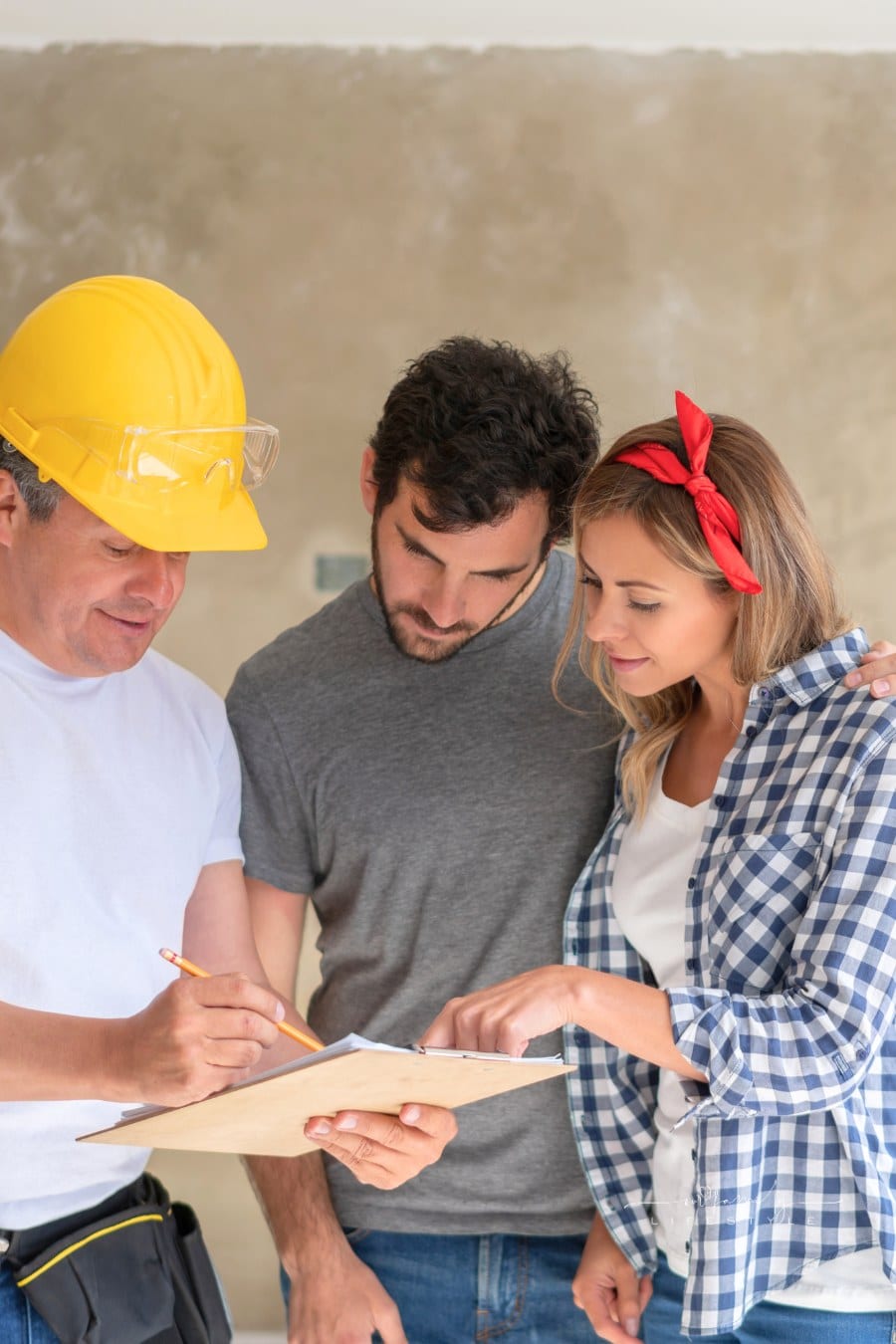 Contractor talking to a couple while remodeling their house