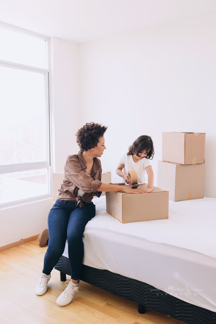 Woman and Child Packing Moving Boxes