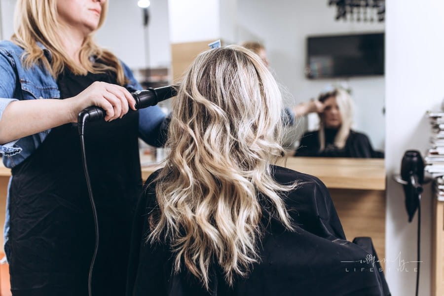 female hairdresser styling a woman's hair