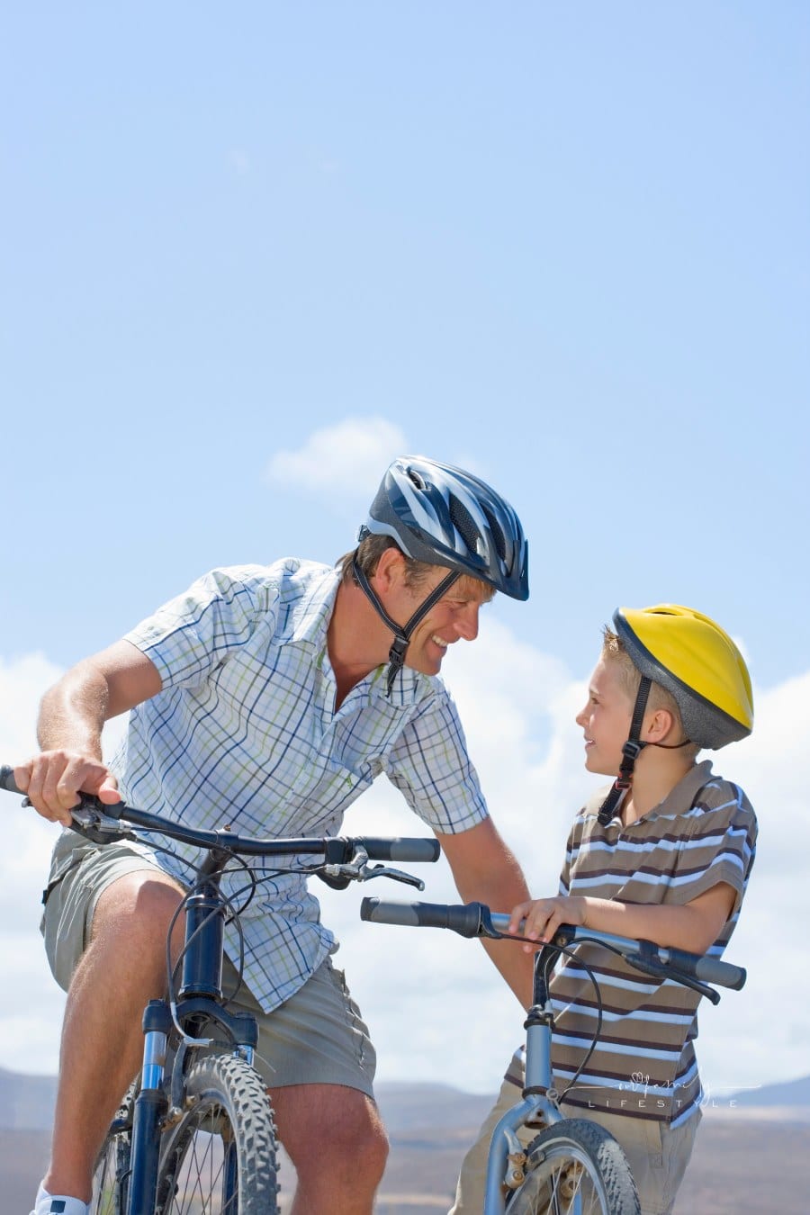 father and son riding bikes together