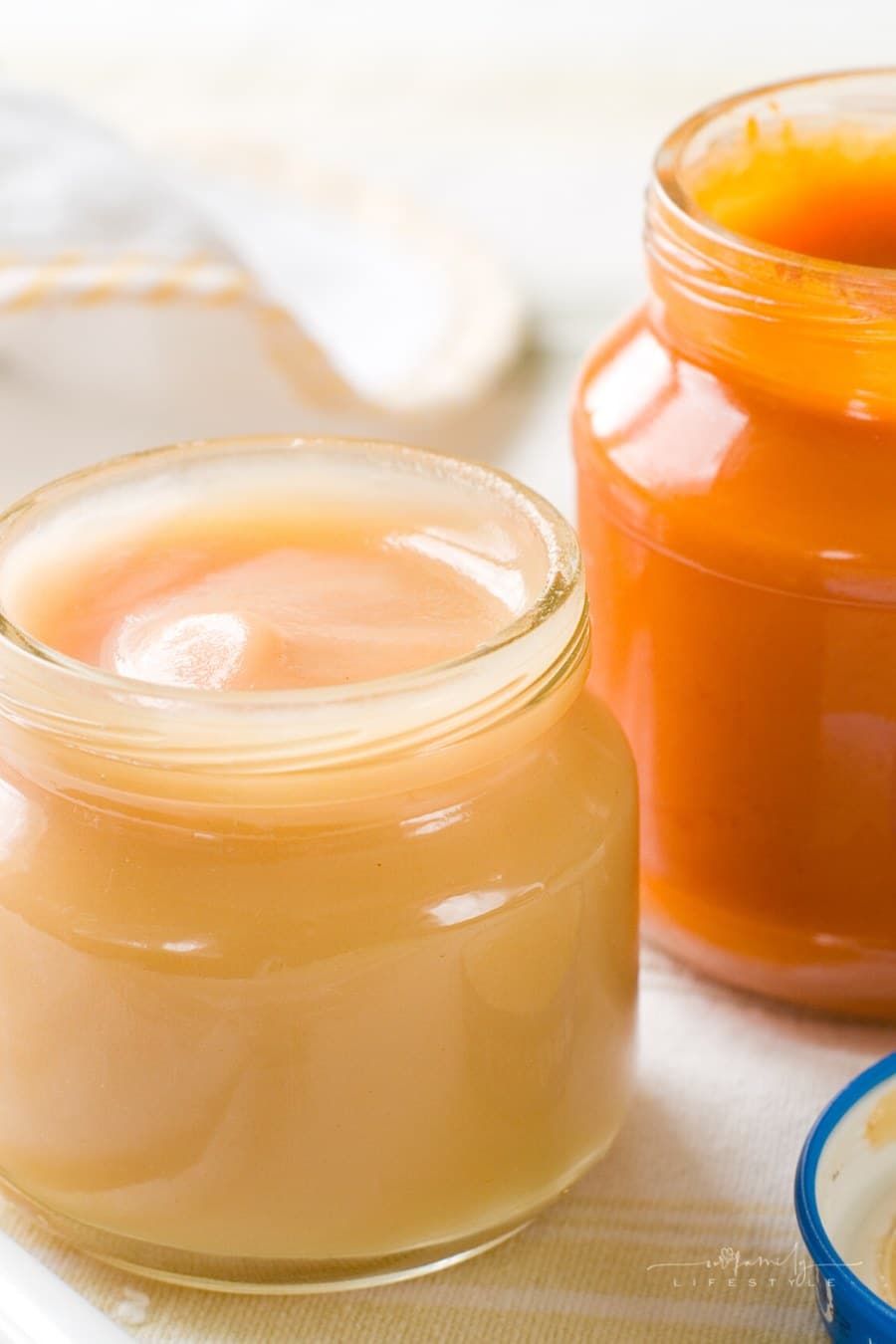 two open jars of baby food sitting on table