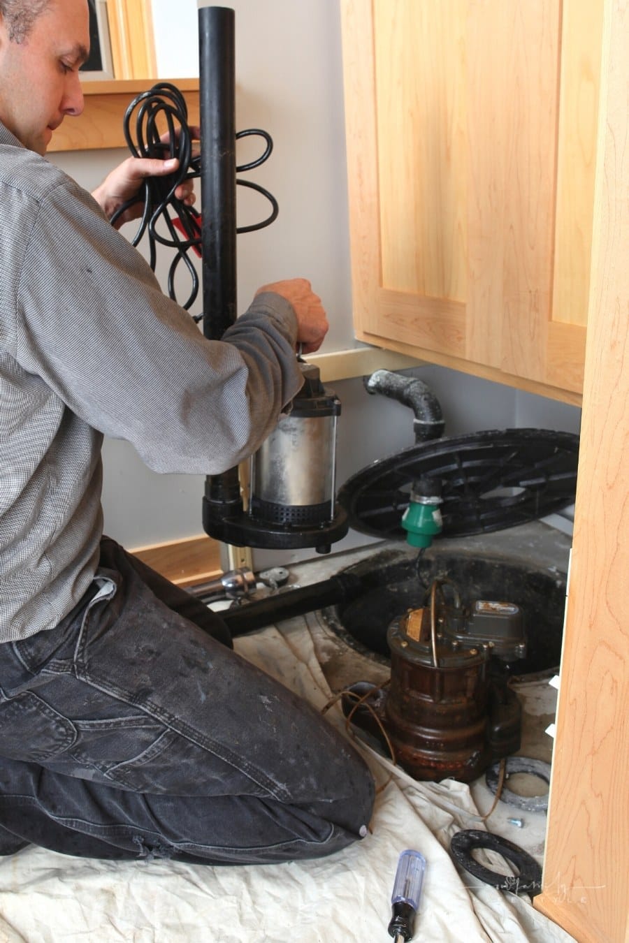 plumber installing new sump pump