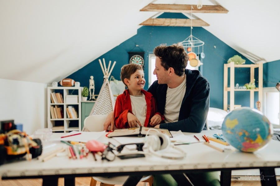 dad and son learning together while homeschooling