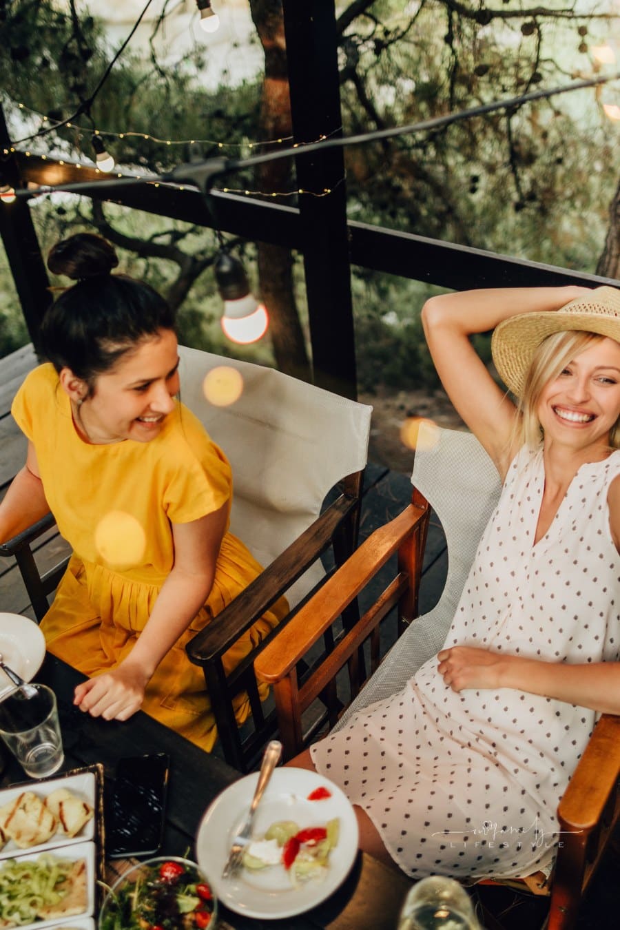 friends laughing at a Summer dinner party