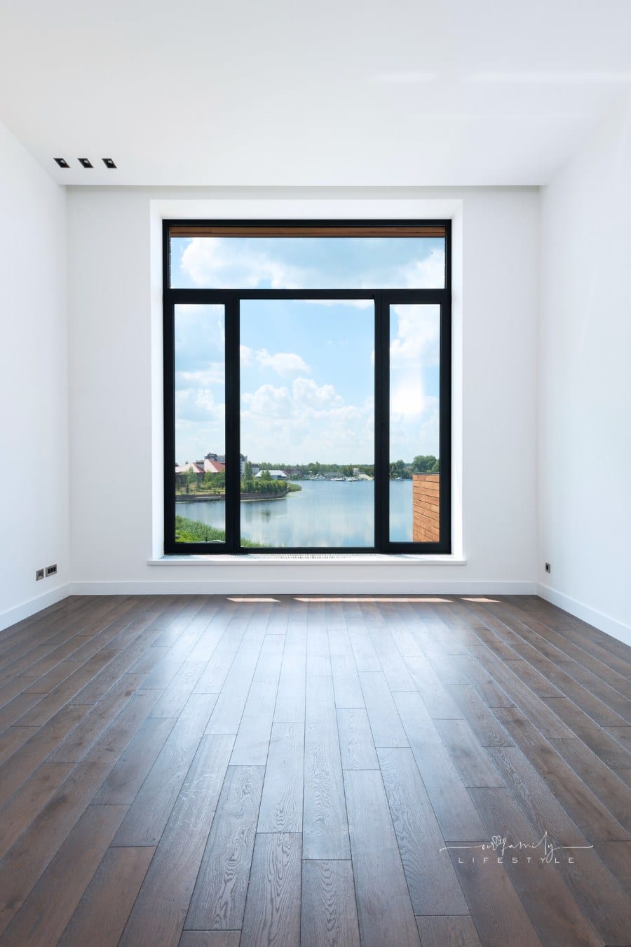 Spacious room with white walls and panoramic windows