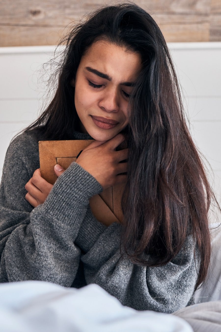 Sad, Loss and Woman Crying with a Photo for Memory While in Bed in the Morning. Depression, Tears and Girl with a Picture Frame in the Bedroom during Grief, Sadness and Sorrow about Death in a House