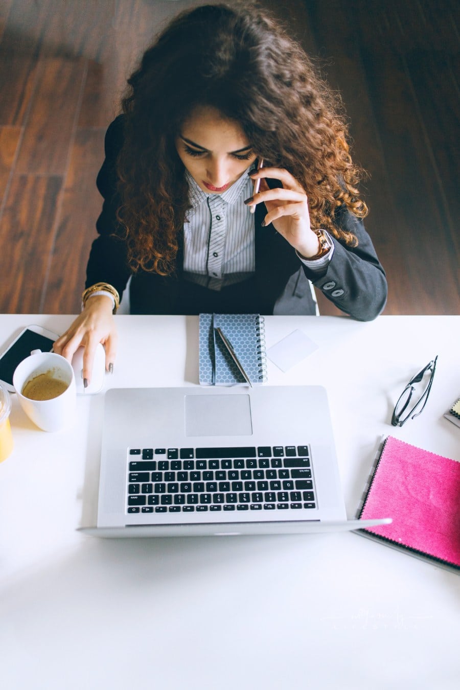 Woman Checking Her E-Mails while talking on the phone