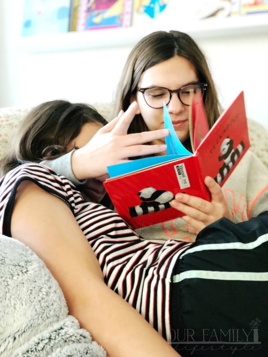 girls reading a book together