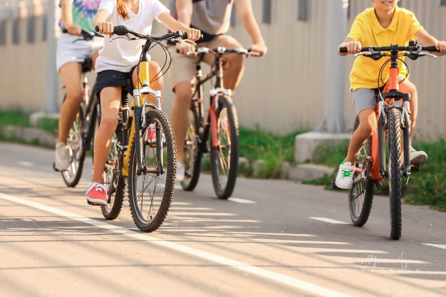 Happy Family Riding Bicycles Outdoors