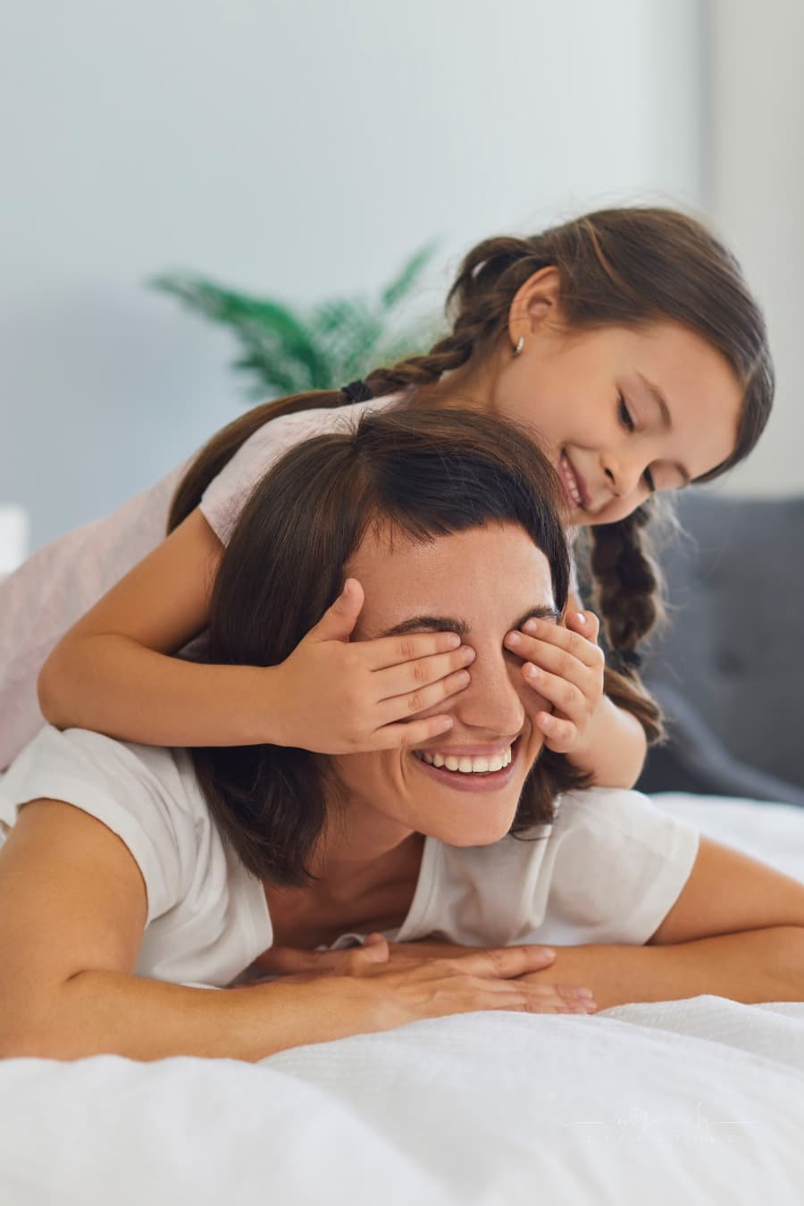 happy mom playing with daughter