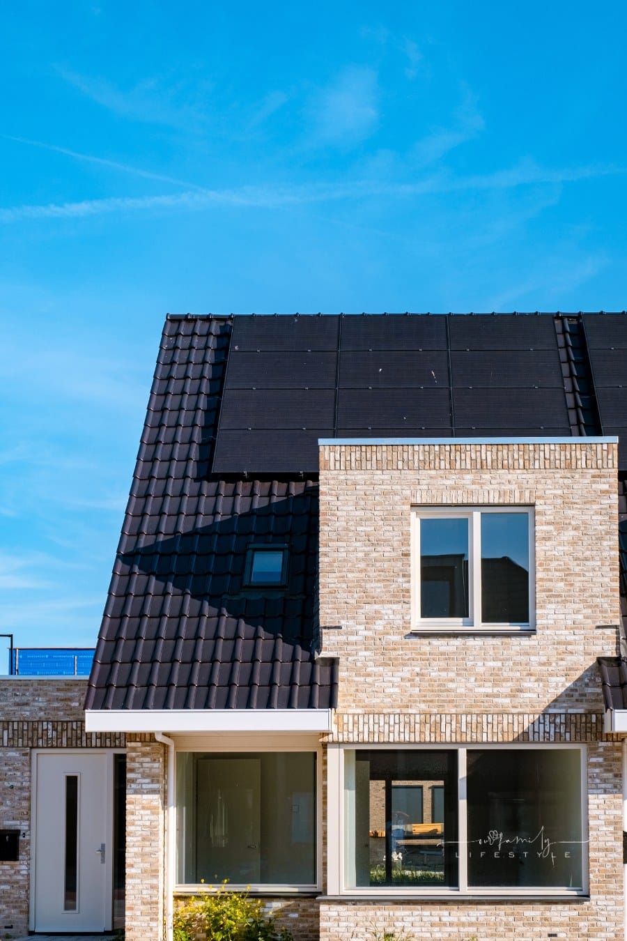 Newly build houses with solar panels attached on roof against a sunny sky Close up of solar panels