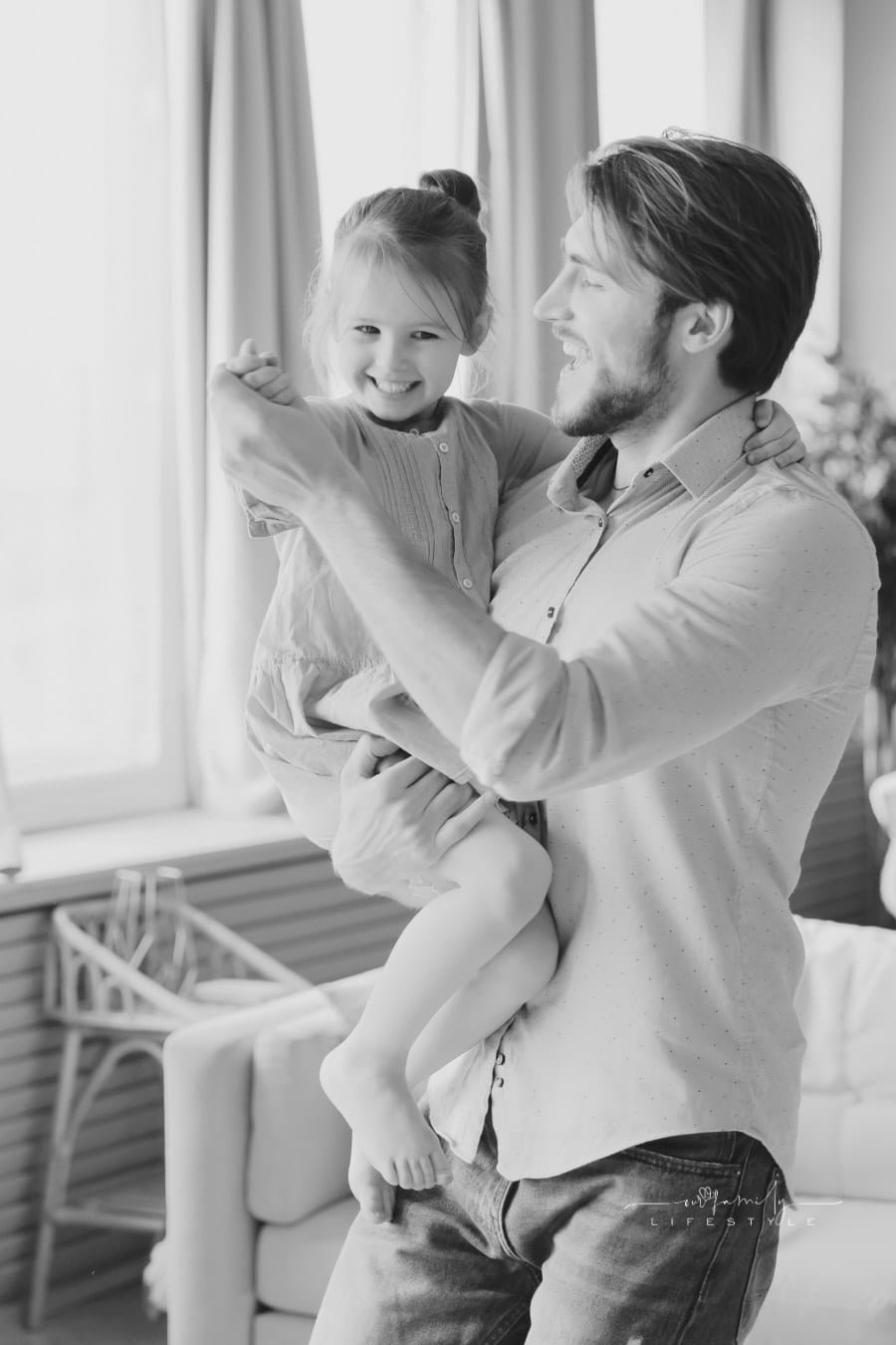 Happy young dad dancing with cute little daughter