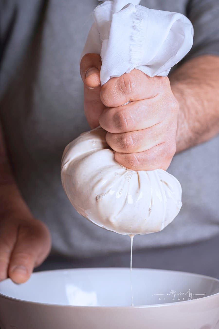 Horchata making, man hands squeezing horchata paste