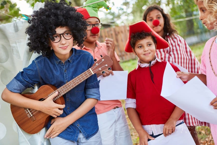 Group of Children at Family Talent Show in backyard