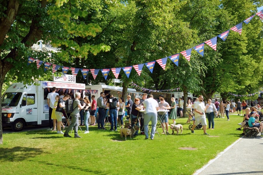 People Having Fun at a Craft Fair with food trucks