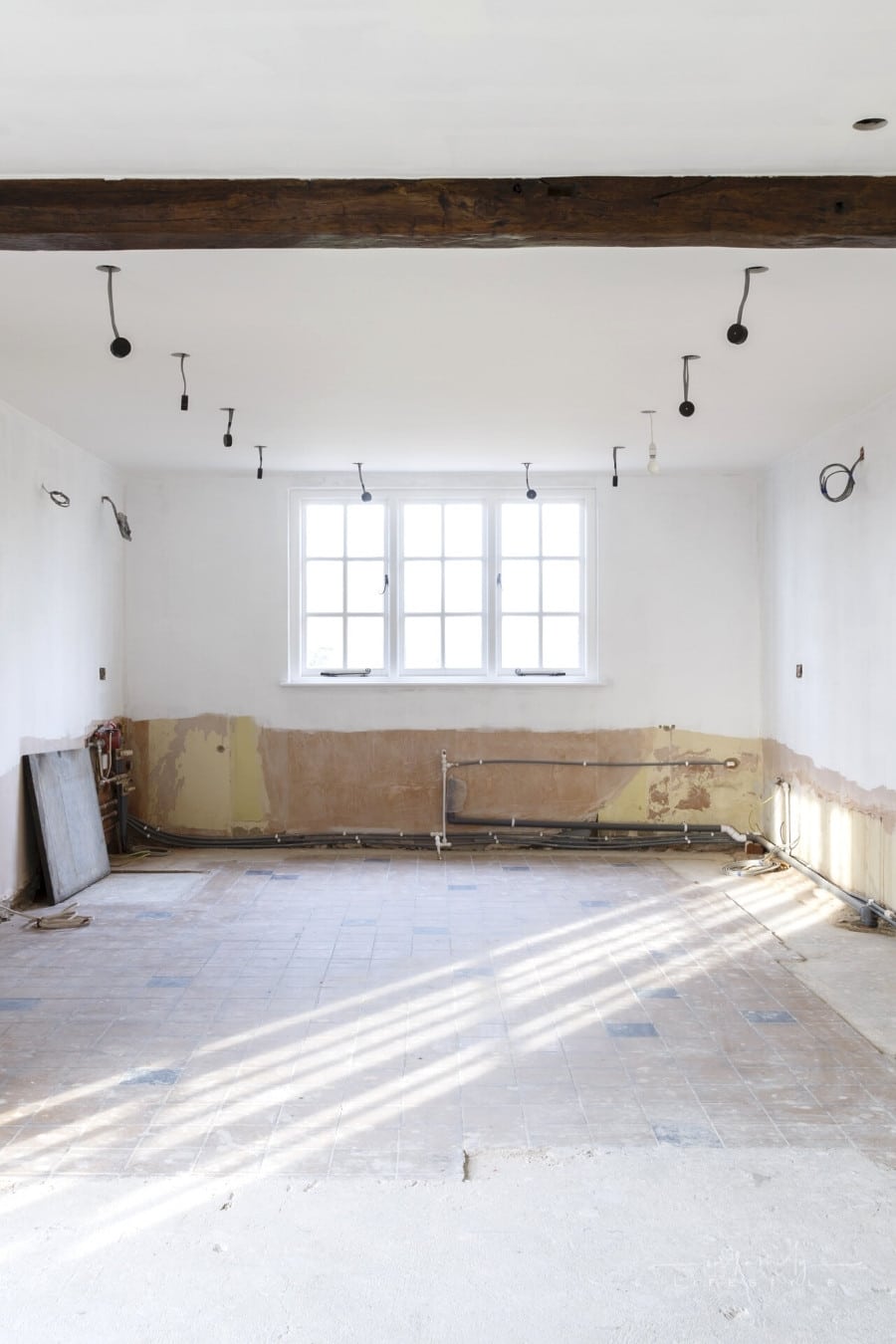 empty kitchen with bare walls undergoing remodeling