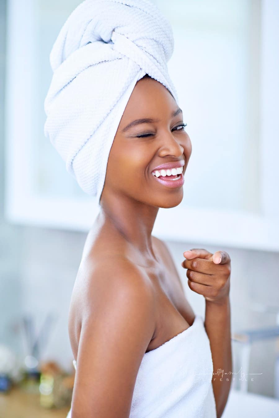 beautiful woman pointing and smiling at the camera during her morning routine