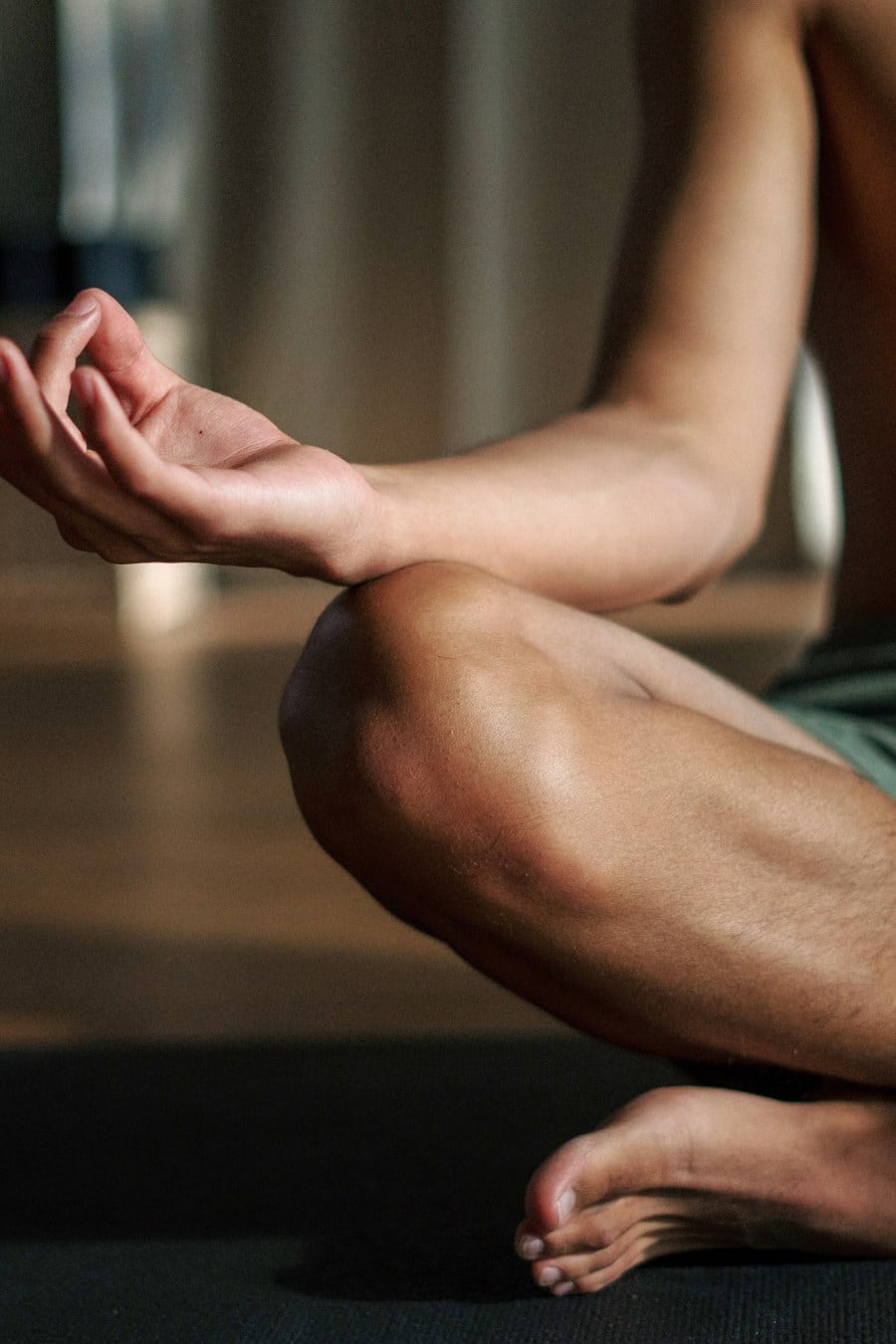 Man in Black Shorts Sitting on Floor Meditating