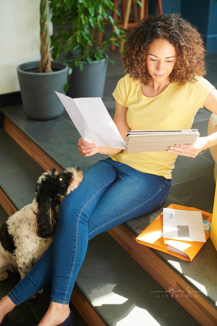 woman choosing pet insurance while her dog looks up at her