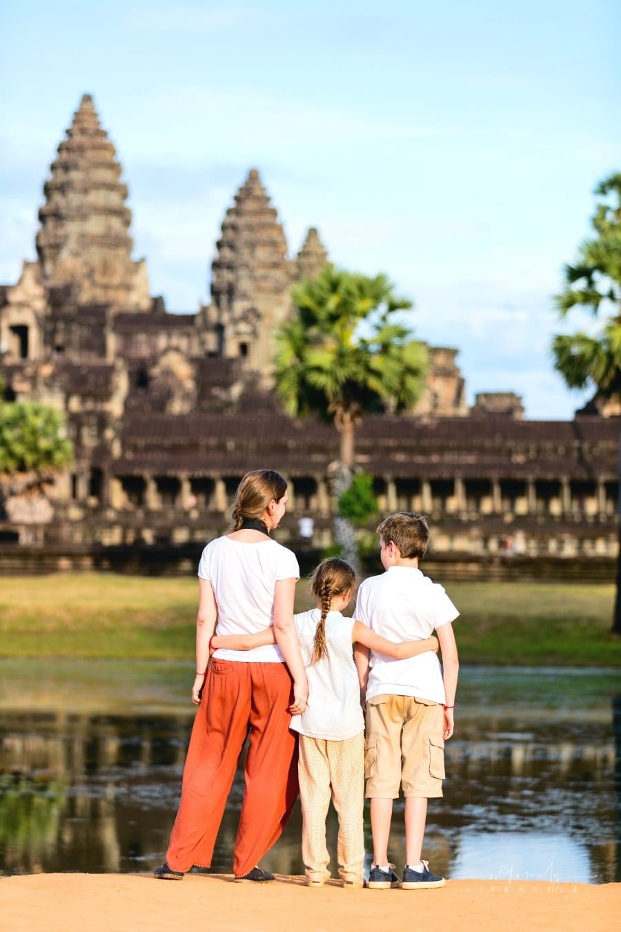 kids standing in front of Angkor Wat Temple in Cambodia