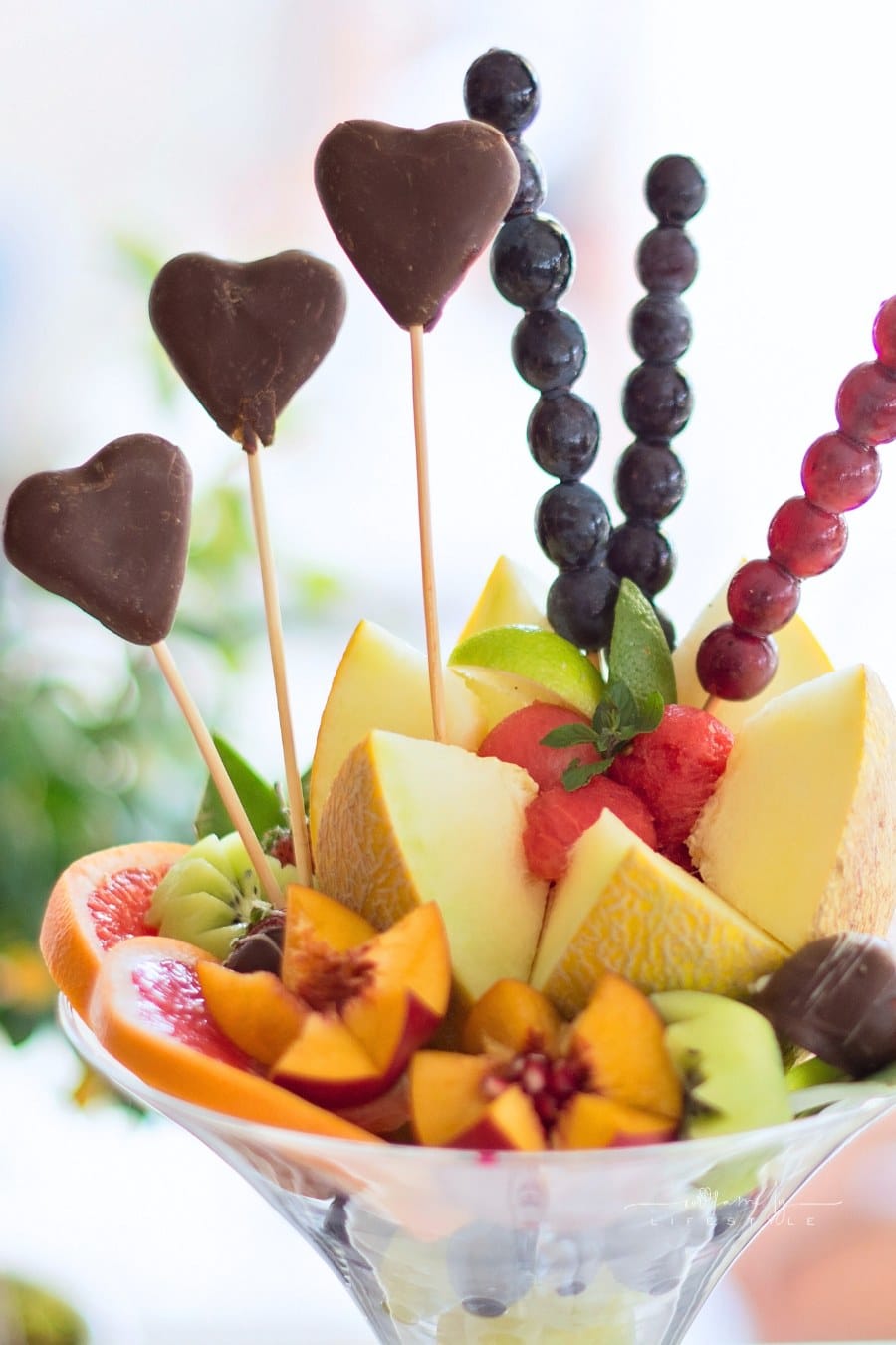 Fruit and chocolate arrangement in glass vase
