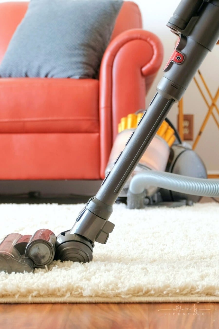 vacuuming a rug in living room