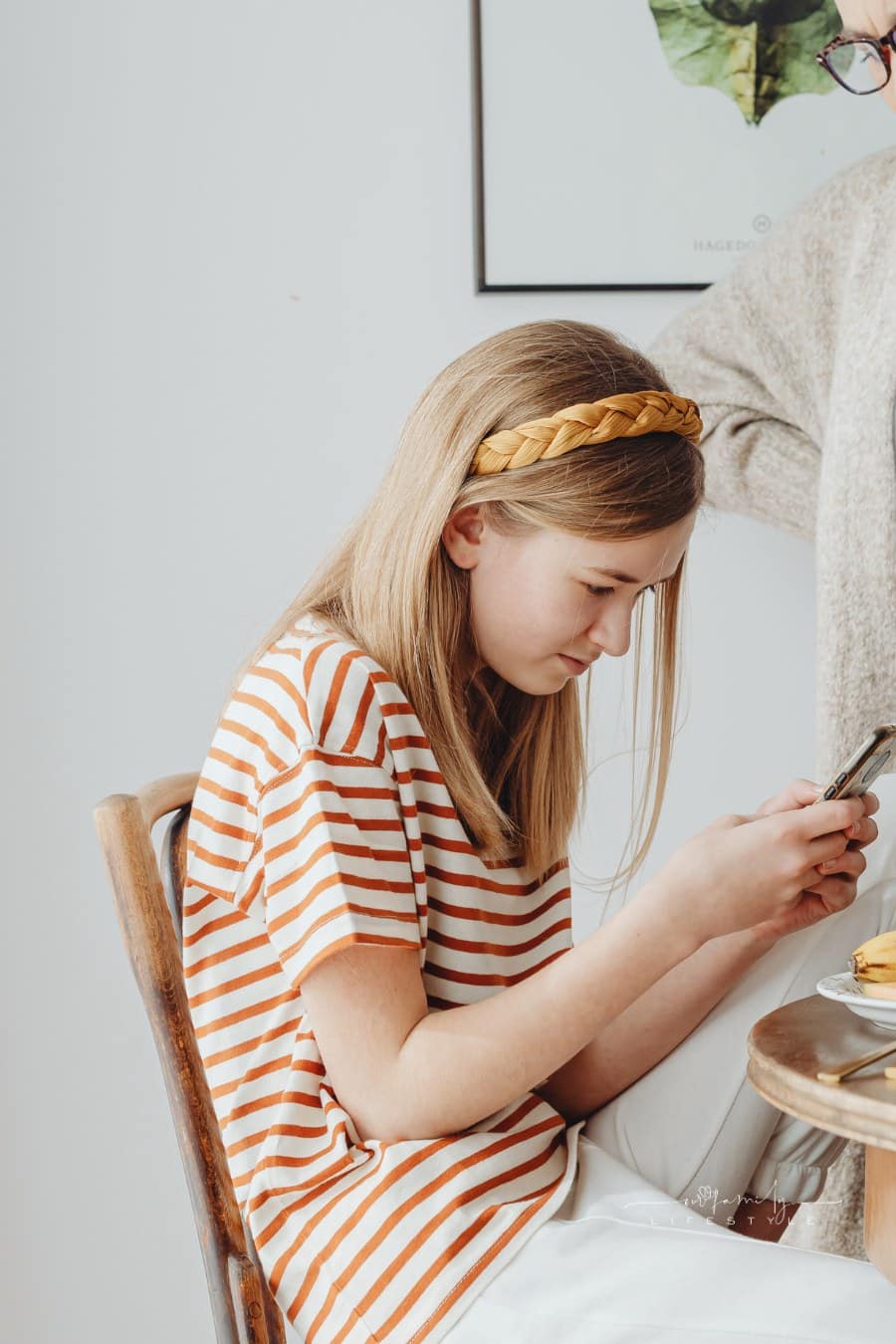Teen Bending Over Phone in Hands