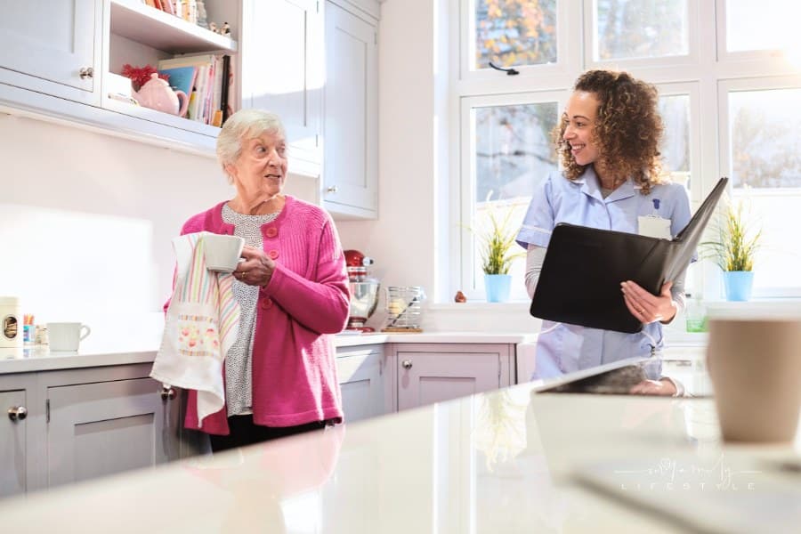 senior woman in assisted living home with female caregiver