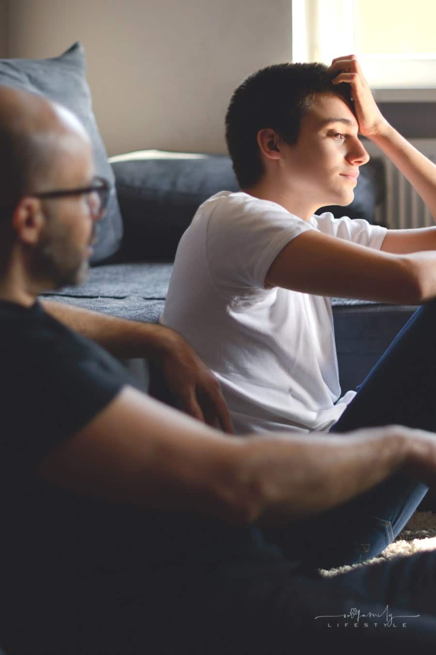 father talking to upset teenage son about a serious topic