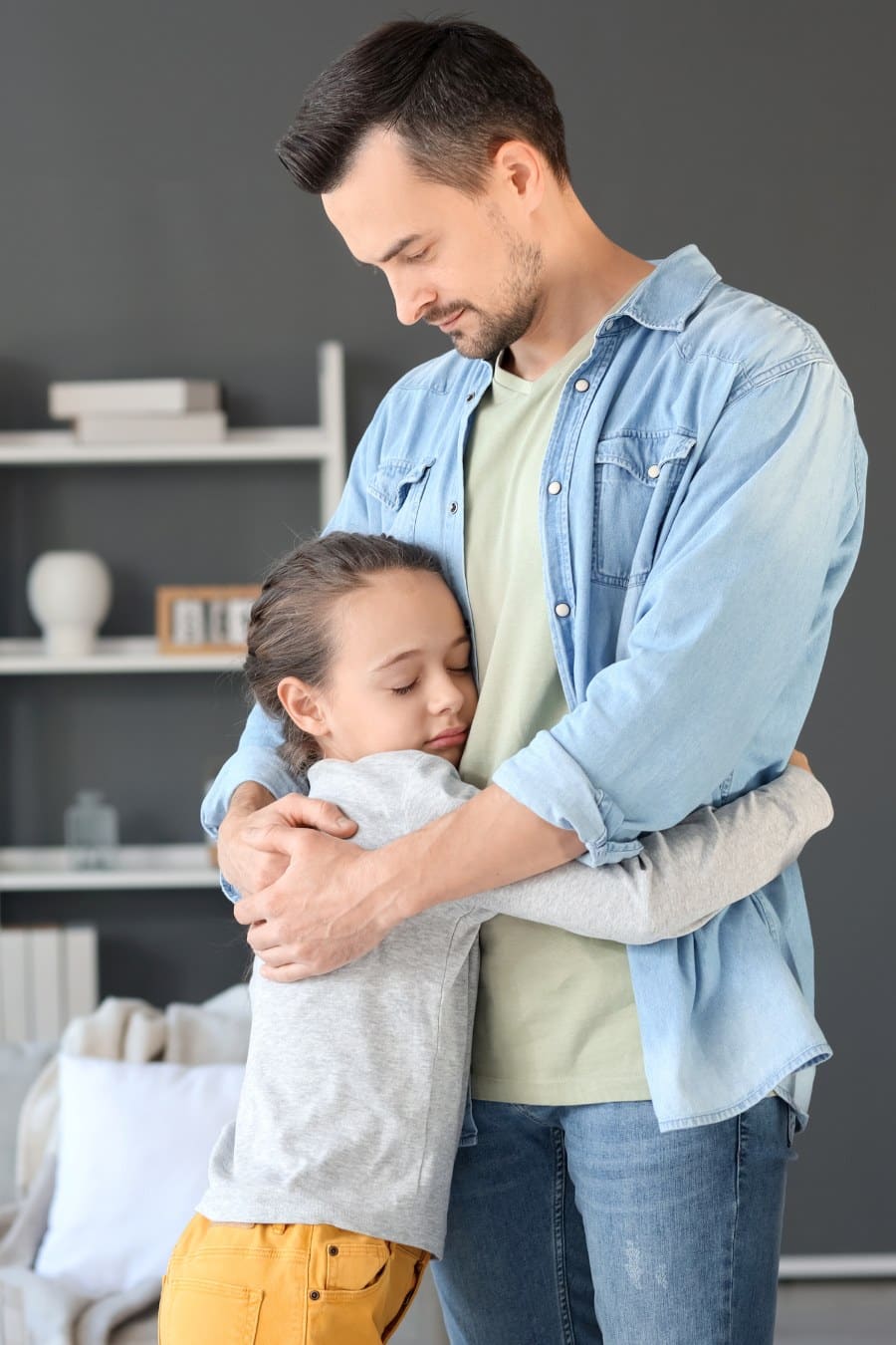 Little Girl Hugging Her Father after Divorce at Home