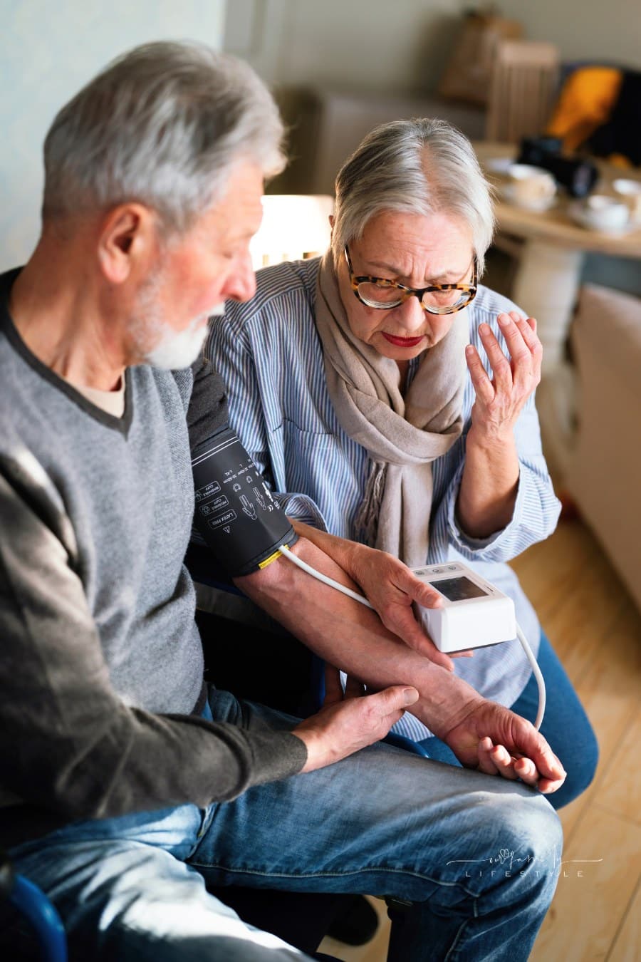 Senior couple at home measuring blood pressure. Home monitoring people healthcare concept