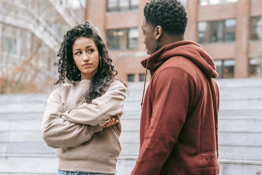 Disappointed multiethnic couple having argument on street