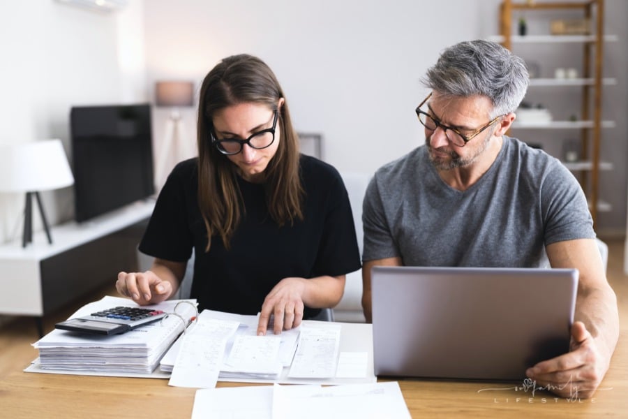 couple looking over receipts while working on family budget