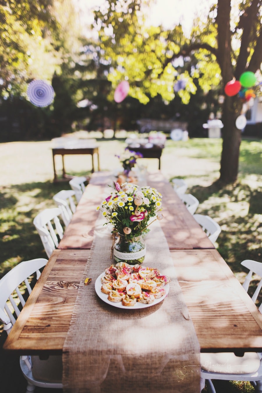 long table decorated and set up for big family garden party