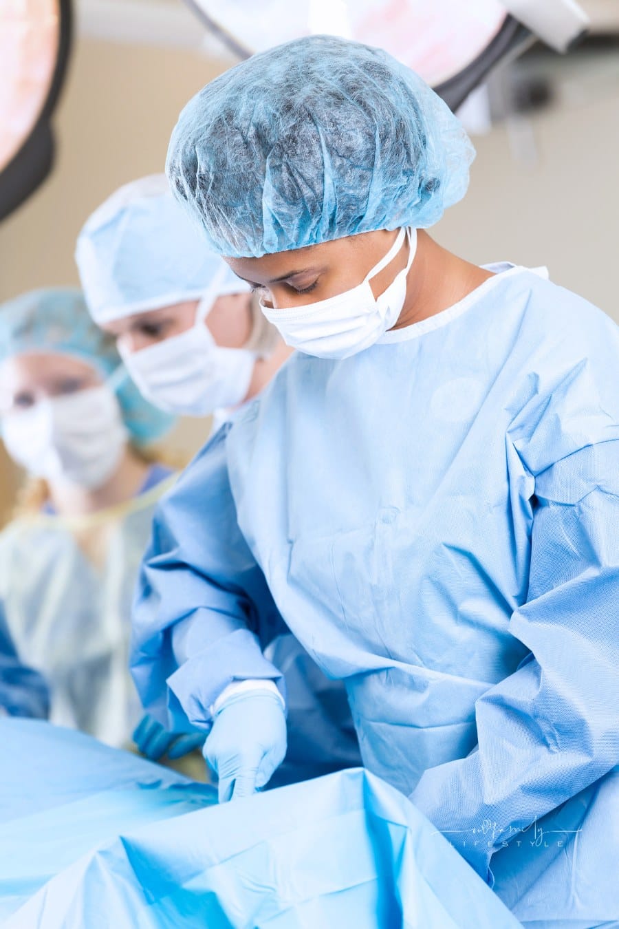Confident female surgeon performing surgical procedure in hospital