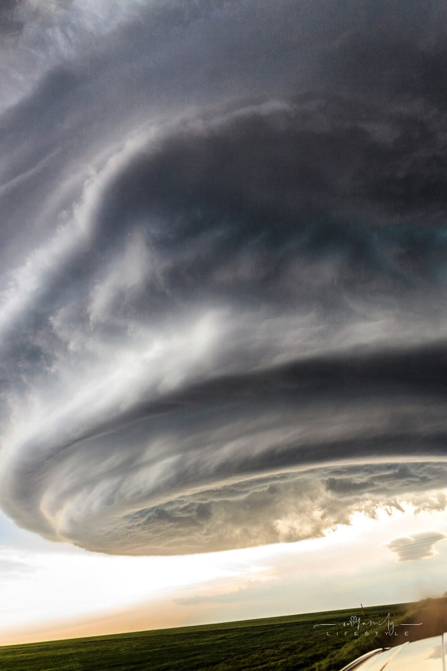 large tornado forming over grassy field