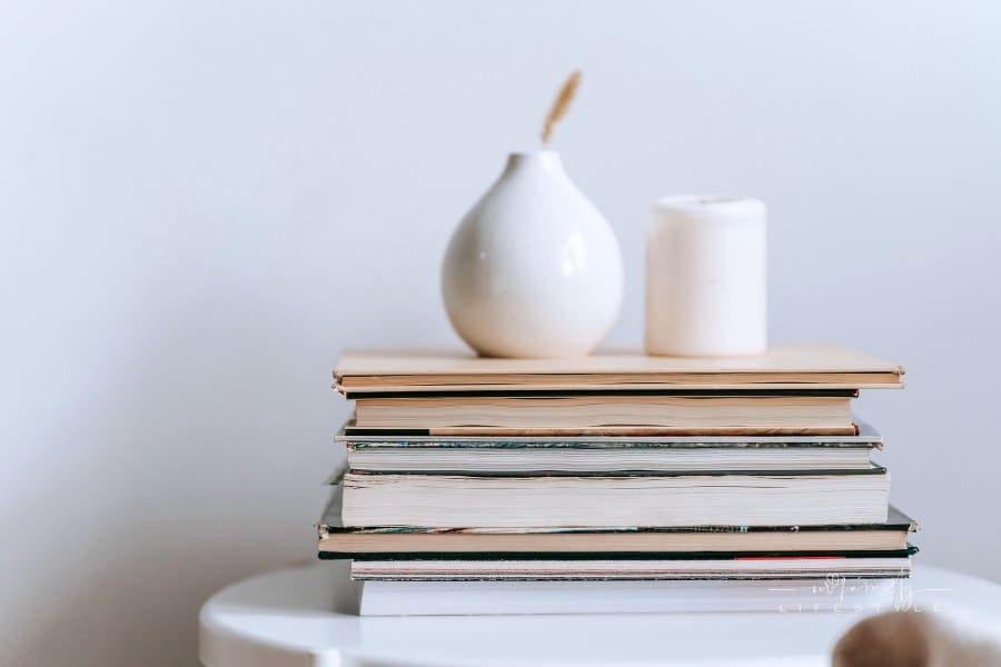stack of books with decorative home accents on top