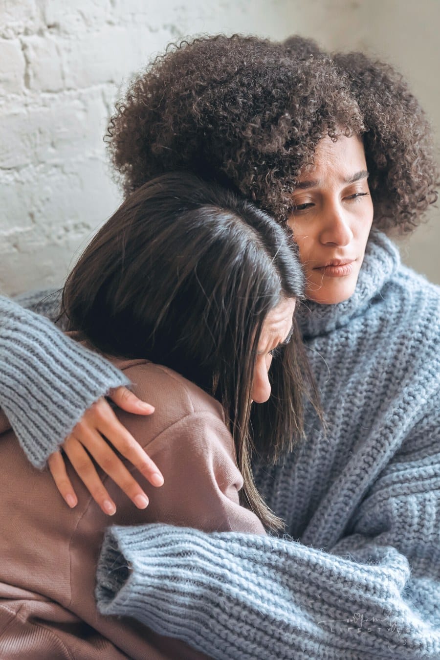 sad woman hugging her friend