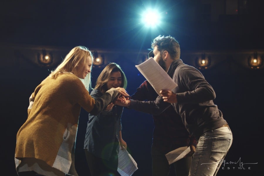 actors celebrating script reading on stage