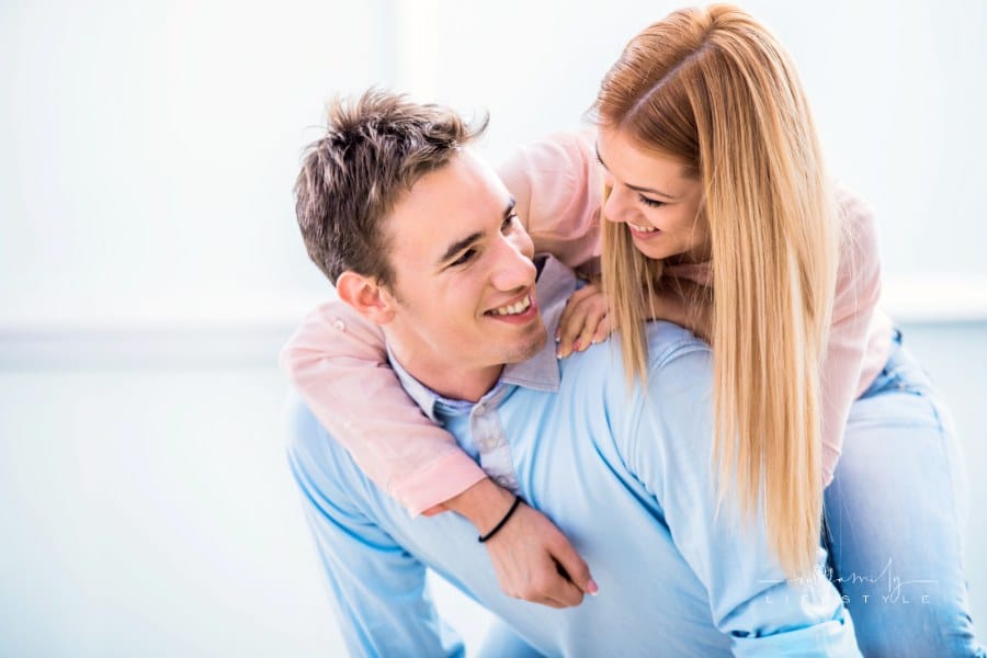 Playful young couple piggybacking.