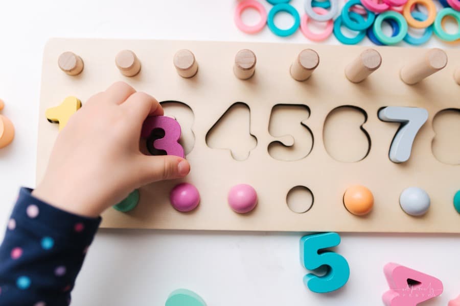 little girl playing with a number puzzle